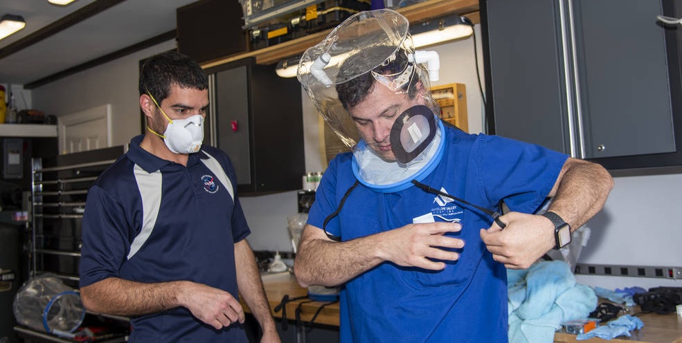 NASA engineers work on an oxygen hood system