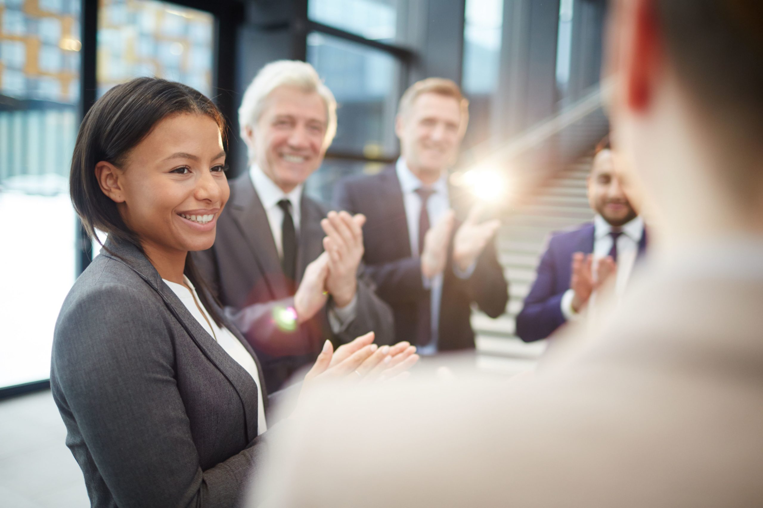 Diverse group of business people laughing and clapping