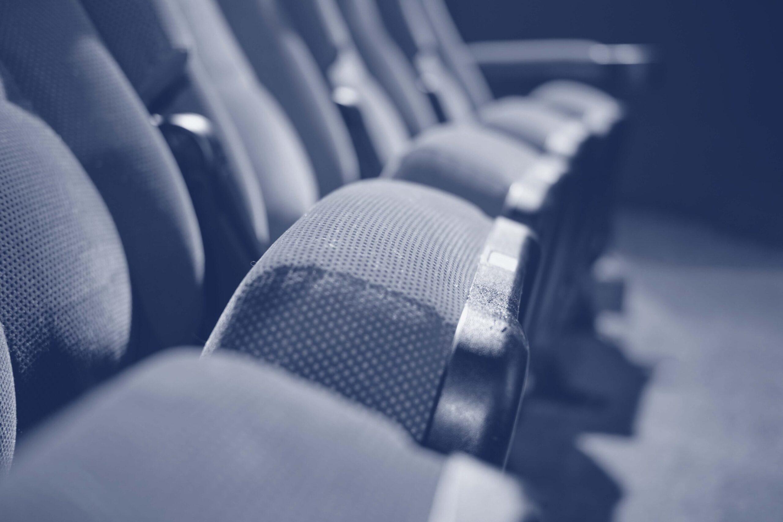 A blue filtered image of empty cinema hall seats