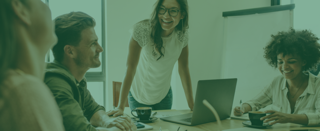 Teal filtered image of people working at a table