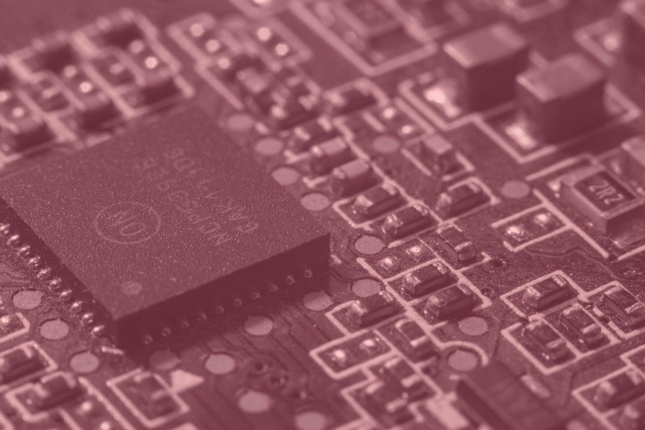 Magenta filtered close up of a microchip