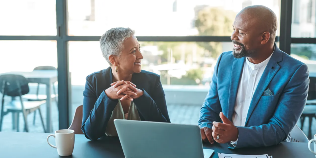 Two people sitting at a table talking